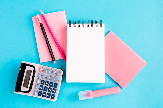 Scratchpad and office tools on blue surface