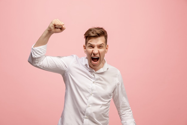 Free photo screaming, hate, rage. crying emotional angry man screaming on pink. emotional, young face. male half-length portrait. human emotions, facial expression concept. trendy colors