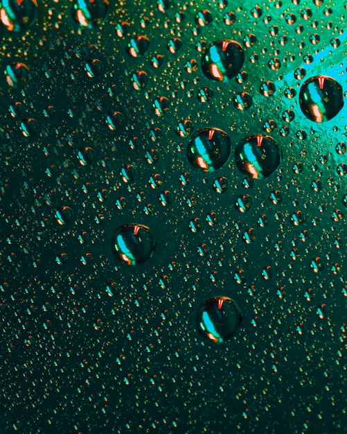 Free Photo seamless pattern of wet water bubbles on green surface backdrop