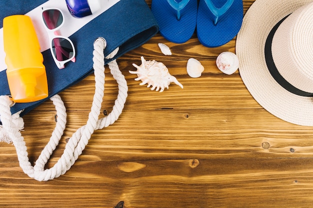 Seashells and beachwear near bag