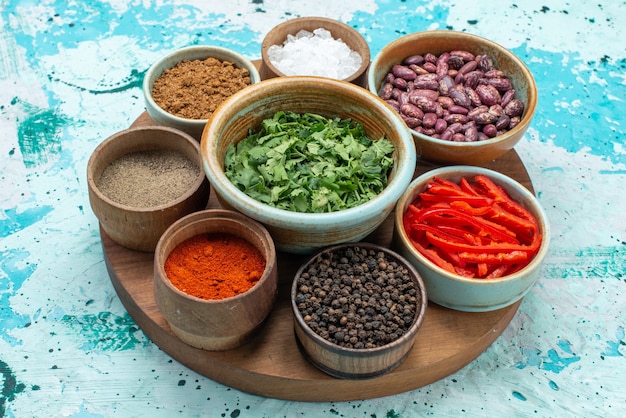 seasonings with greens salt pepper on light-blue