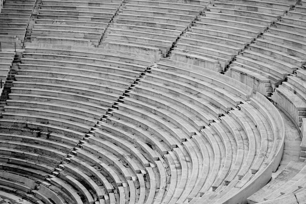 The seats of a large stadium field in black and white