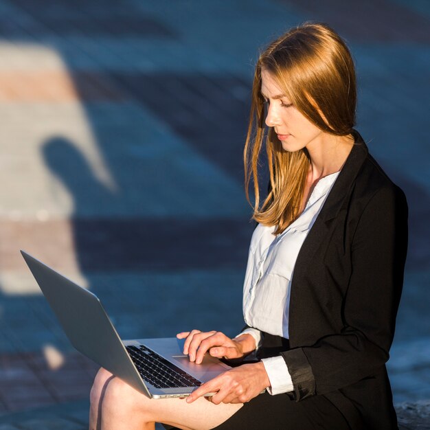 Secretary using her laptop outdoors