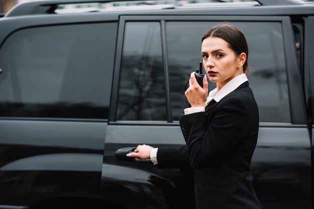 Free Photo security woman in front of car