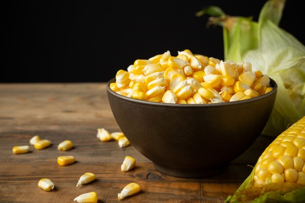 seeds and sweet corn on wooden table.