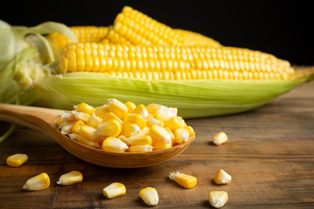 seeds and sweet corn on wooden table.