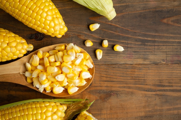 seeds and sweet corn on wooden table.