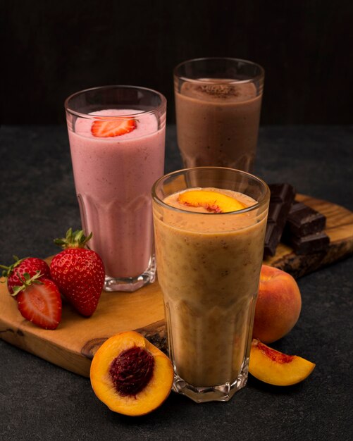 Selection of three milkshake glasses with fruits and chocolate