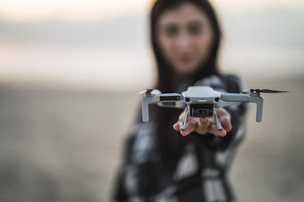 Free Photo selective focus of drone on the hand of a young caucasian girl from spain