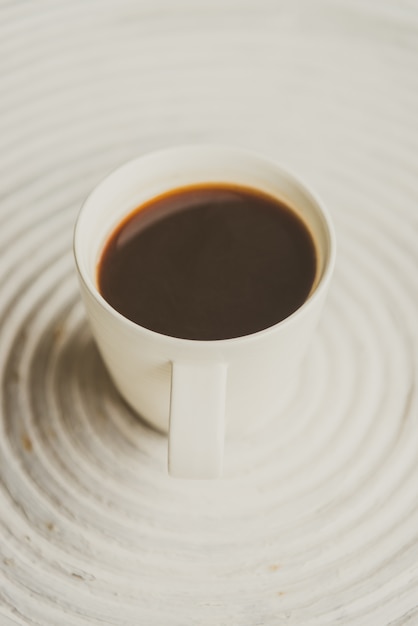 Selective focus point on black coffee in white cup