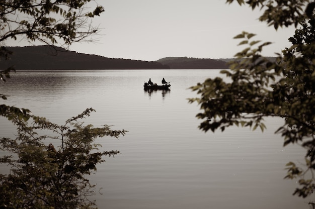 Free photo selective focus shot of a boat on a lake in the evening