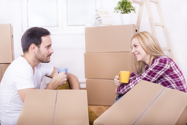 Selective focus shot of a happy white couple moving in together into a new house