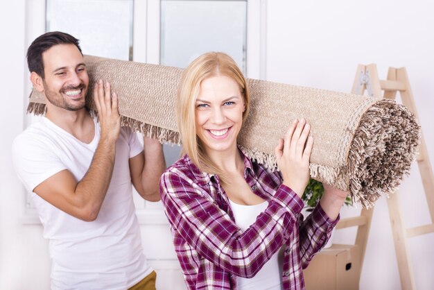 Selective focus shot of a happy white couple moving in together into a new house