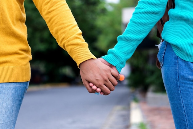 Selective focus shot of ladies holding hands