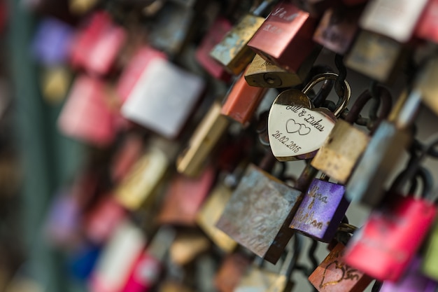 Free photo selective focus shot of a love padlock on a fence