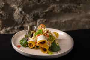 Free photo selective focus shot of mexican style delicious pork flautas on a white plate