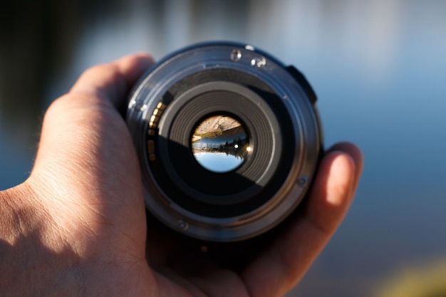 Free Photo selective focus shot of a person holding a camera lens