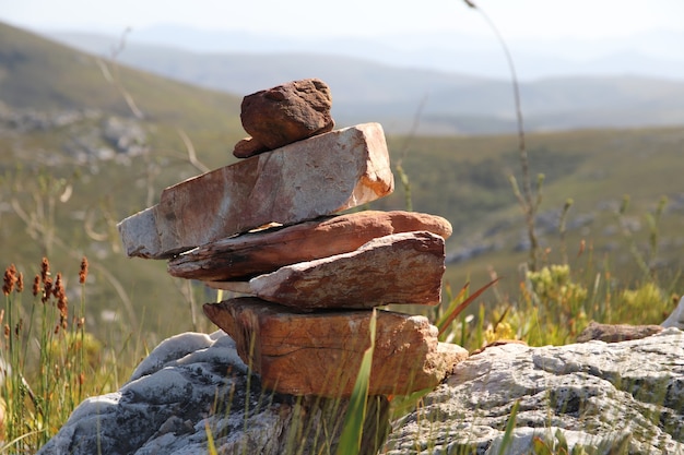 Free photo selective focus shot of a pile of rocks on the hills at daytime