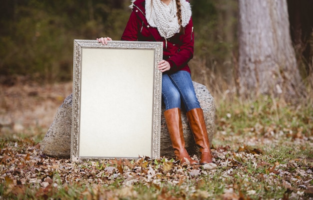 Free photo selective shot of a person holding a blank picture frame