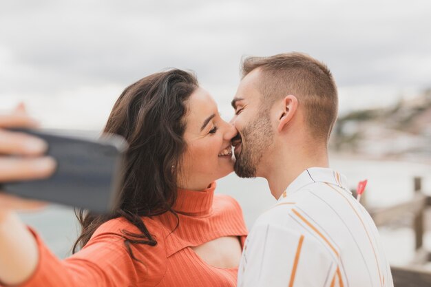 Selfie with couple kissing