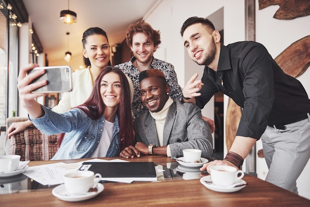 Selfie of young smiling people having fun together.