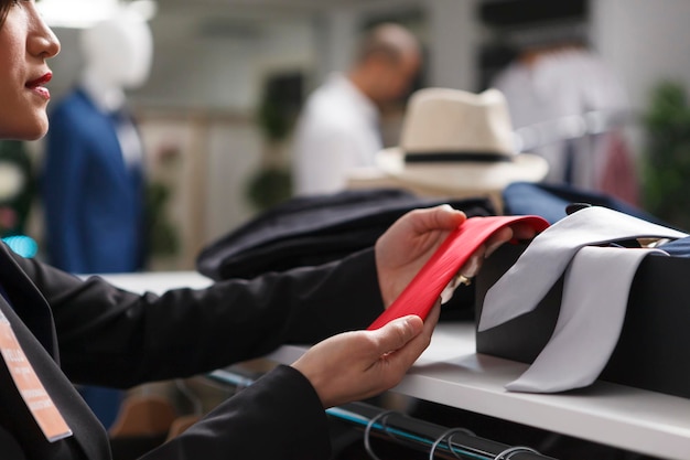 Free Photo seller arms examining red tie closeup