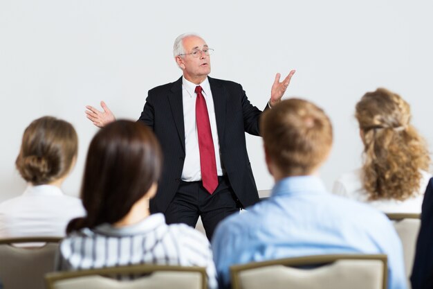 Senior business man giving a lecture