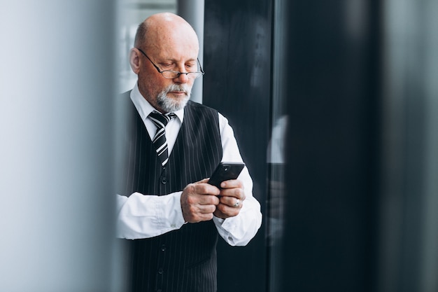 Senior businessman talking on the phone at the office