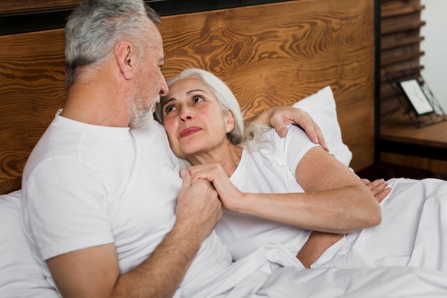 Senior couple on bed on valentines day