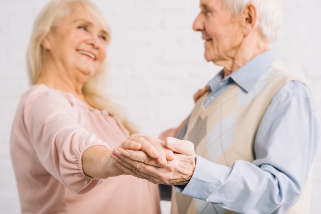 Senior couple dancing in kitchen