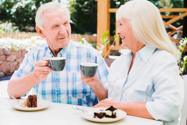 Senior couple drinking tea on outdoors veranda