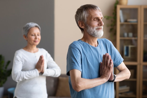 Senior couple exercising at home