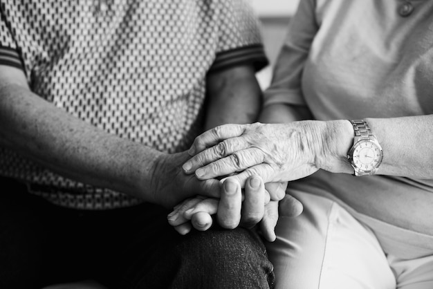 Free photo senior couple holding hands together