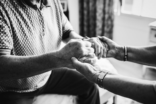 Free photo senior couple holding hands together