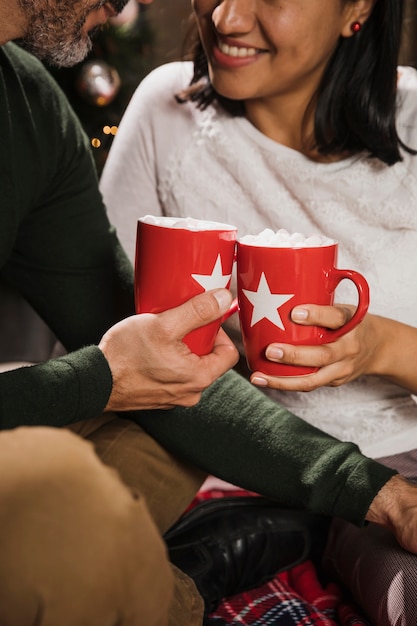 Free photo senior couple holding warm mugs