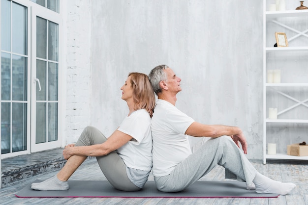 Free Photo senior couple resting after exercise in living room