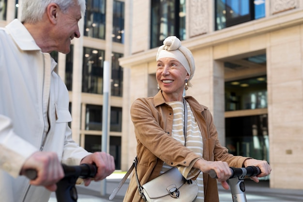 Senior couple riding an electric scooter in the city