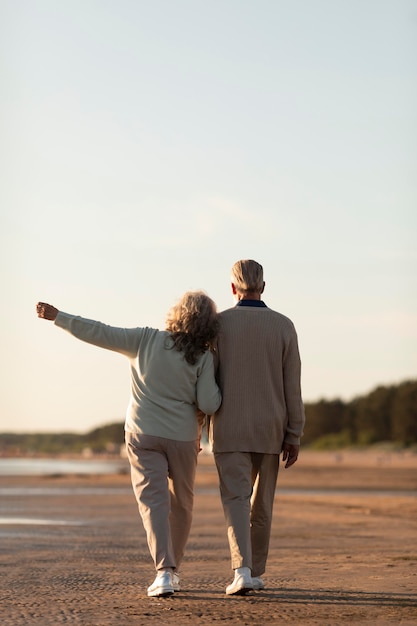 Free photo senior couple at seaside full shot