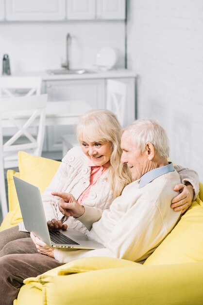 Senior couple using laptop