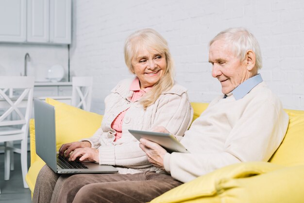 Senior couple using laptop