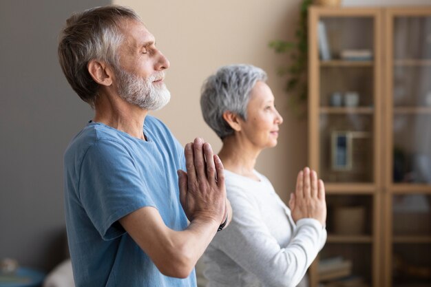 Senior couple working out together at home