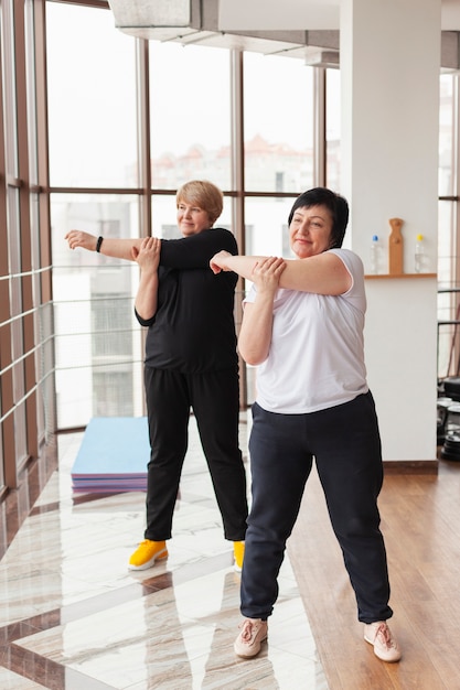 Senior female couple stretching