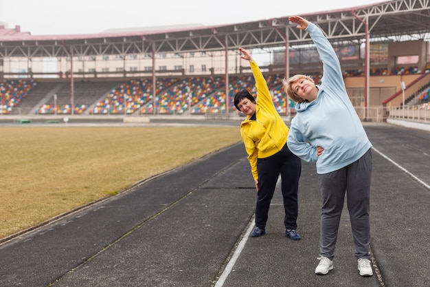 Senior females on stadium stretching