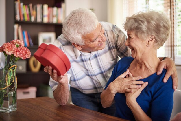 Senior husband giving a present to his wife