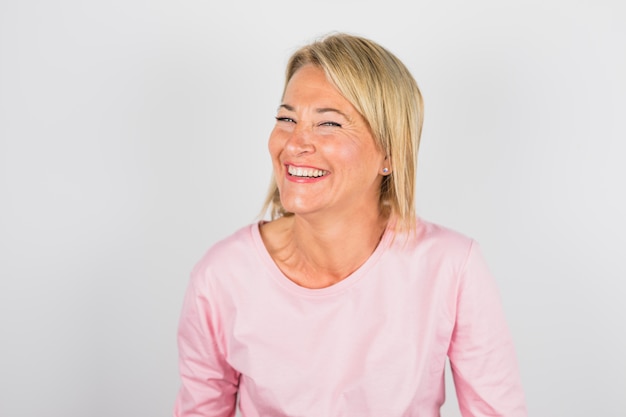 Senior laughing woman in rose blouse