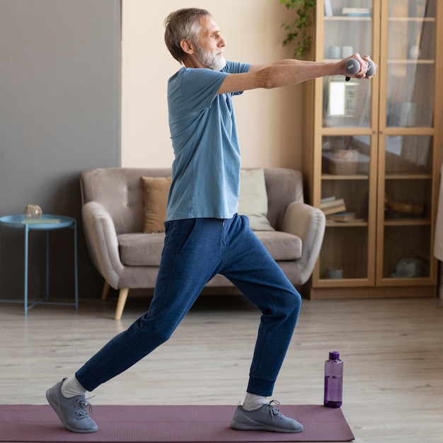 Senior male working out at home