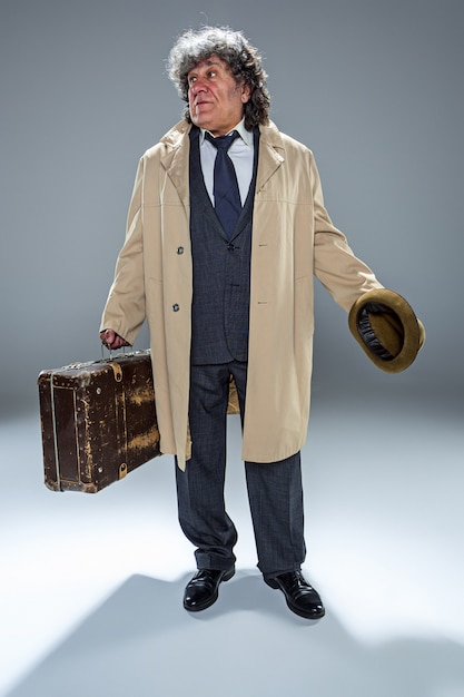 Free Photo the senior man as detective or boss of mafia on gray studio background