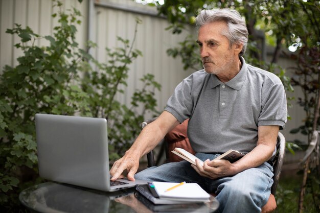 Senior man doing online classes on a laptop