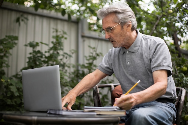 Senior man doing online classes on a laptop