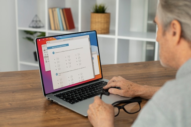 Senior man doing online classes on a laptop